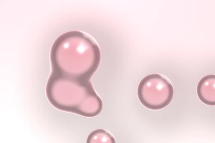 Pink glass bubbles, one large and lumpy and three small and round, floating over a soft pale pink ground, each with a bright reflection near its top.